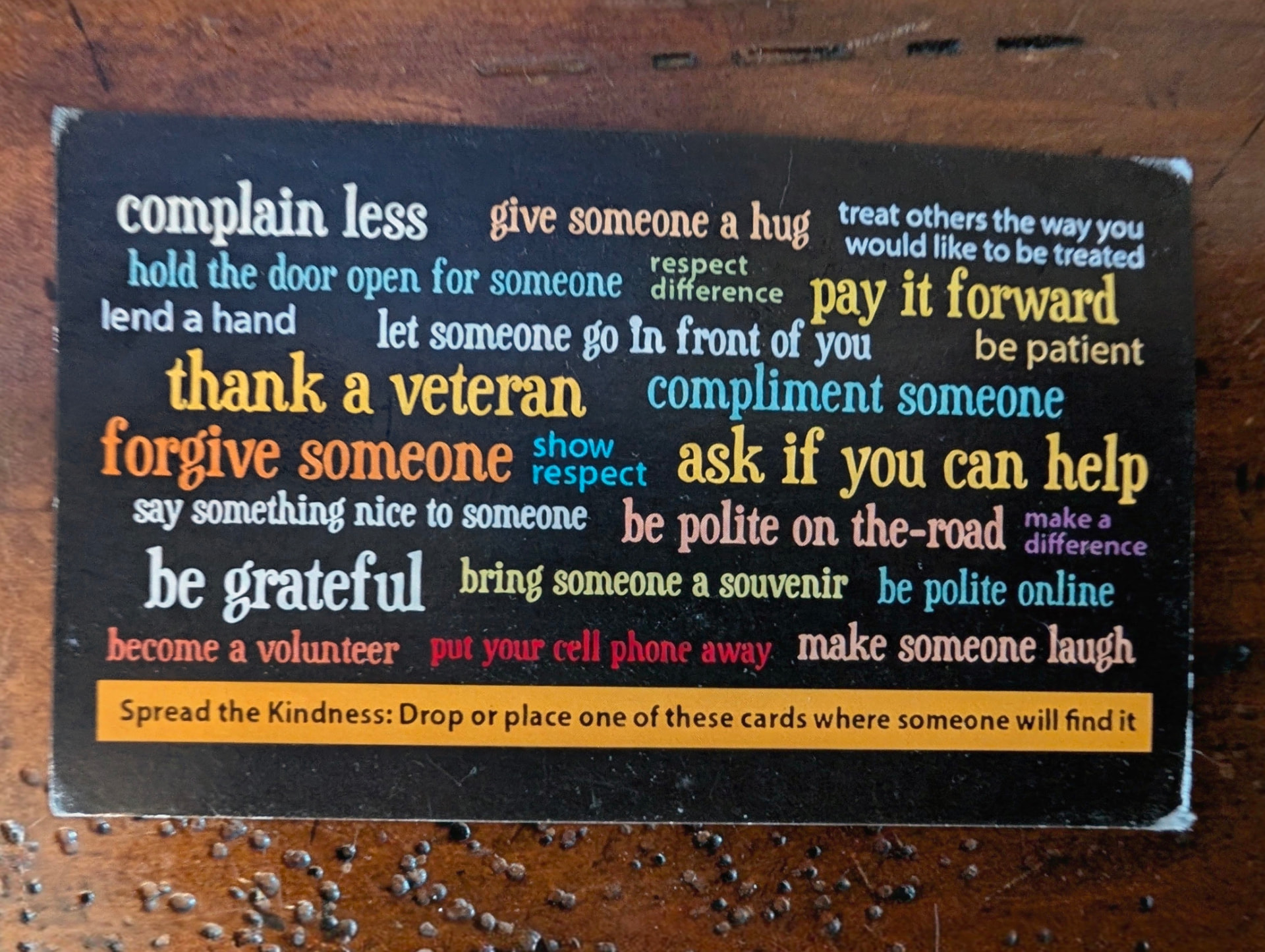 The back of the "Kindness Matters" card, listing prompts like "complain less," "thank a veteran," and "be grateful."